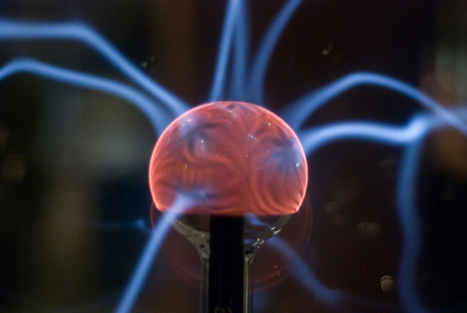 Plasma Globe Symbolizing Quantum Energy Fields A quantum manifestation plasma globe with electric blue tendrils radiating from a glowing red core.
