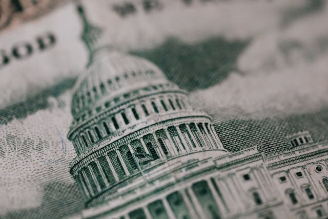 Close-up of the U.S. Capitol building on dollar bill symbolizing power and control over money and policy.