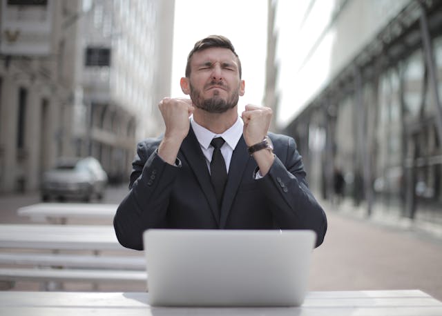 Success Moment: The Power of Daily Money Prayer Man celebrating financial breakthrough after practicing daily money prayer