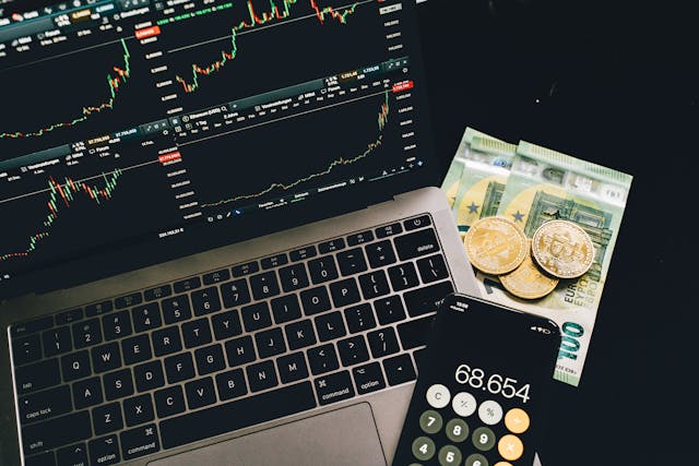 Build Smarter Income Paths Laptop with market charts, euros, and a calculator representing strategies to escape the 9 5 rat race.