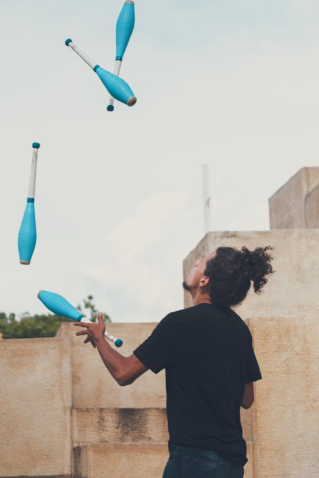 Man juggling clubs outdoors, symbolizing scientific proof of manifestation and how the brain reshapes with practice