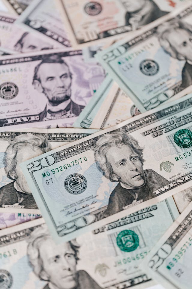 Close-up of scattered U.S. dollar bills, symbolizing affirmations for financial freedom and an abundance mindset