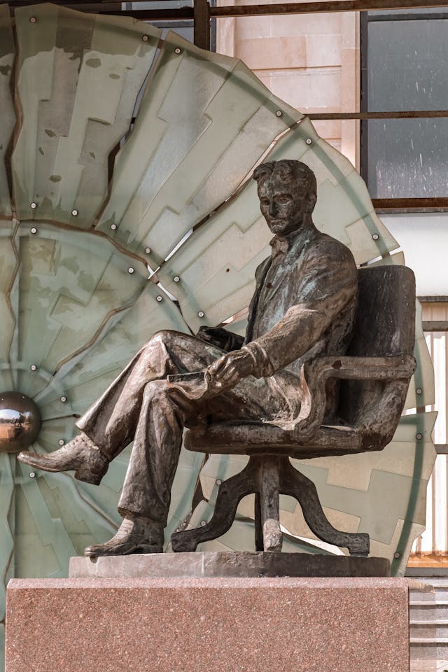 Portrait of Nikola Tesla with abstract energy waves, symbolizing the connection between the law of vibration and law of attraction