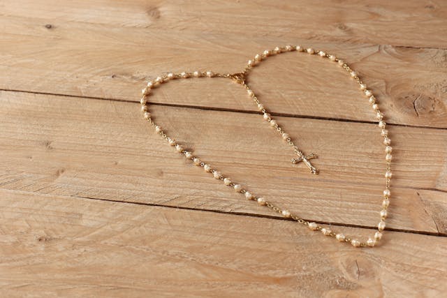 Rosary Heart: Trusting God’s Plan for Your Life Pearl rosary shaped like a heart on a wooden table, symbolizing what is God’s plan for your life