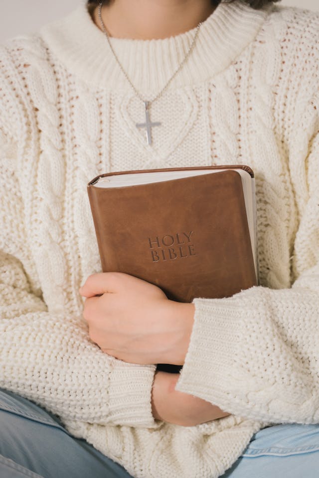 Person holding a Holy Bible close to the chest, expressing what does the bible say about the subconscious mind and storing truth in the heart