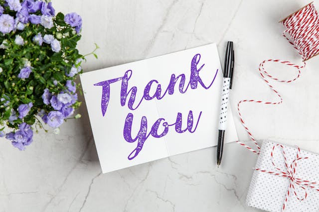 Gratitude Dissolves the Signs Your Manifestation Is Not Coming Thank you card, pen, and gifts illustrating gratitude to counter signs your manifestation is not coming