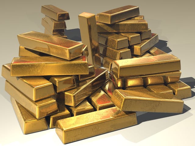 Pile of shiny gold bars symbolizing wealth, prosperity, and the 5 most powerful mantras for abundance