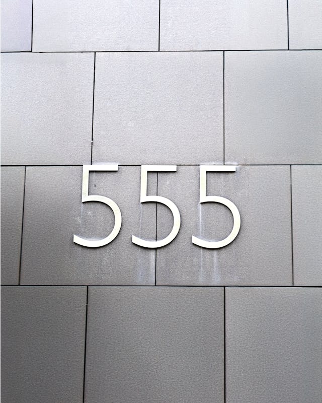 555 Meaning for Manifestation Quotes for Money Large “555” numerals on a gray tiled wall linked to manifestation quotes for money
