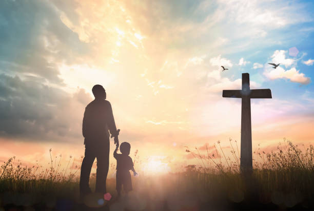A Father’s Guidance and God’s Voice at Sunrise Father and child standing near a cross at sunrise, symbolizing guidance and how to know God is speaking to you.