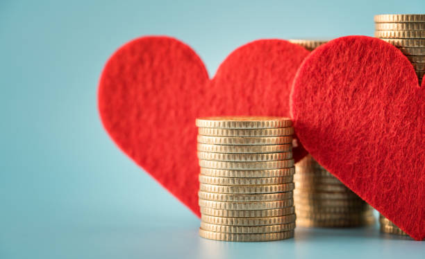 Lead With Heart, Welcome Abundance Red felt hearts standing beside neat stacks of gold coins on a clean blue background.