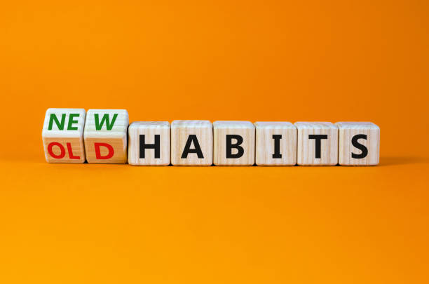 Building New Patterns — Daily Manifestation Routine for Positive Change Wooden cubes display the words “New Habits” against an orange background, symbolizing transformation through a consistent daily manifestation routine.