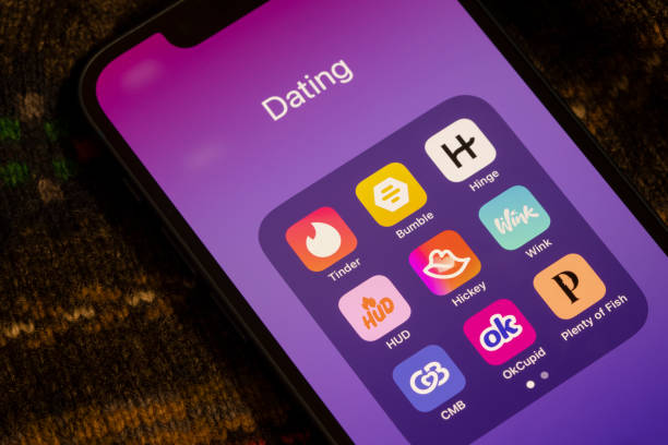 Close-up of a smartphone home screen showing a folder full of popular dating apps.
